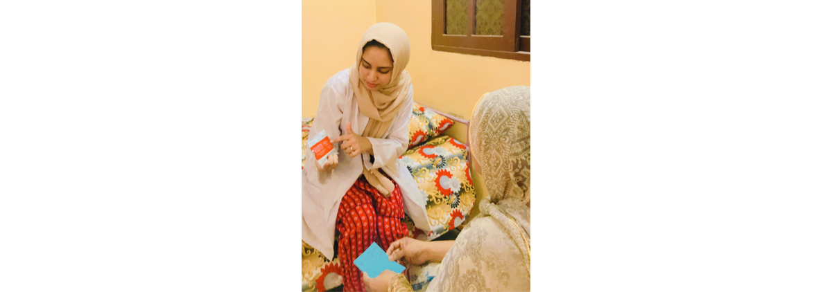 Zehra sits in discussion with another woman